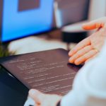 Person using AI tools for content creation on computer workstation