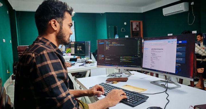 Professional developer workspace with web development tools displayed on monitors