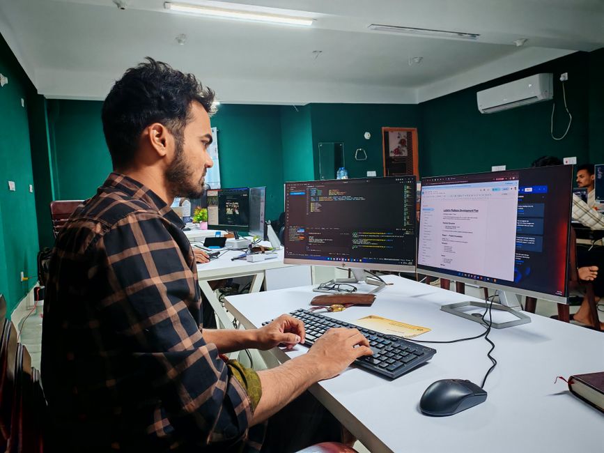 Professional developer workspace with web development tools displayed on monitors