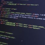 beginner web developer learning to code on laptop