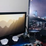 Two monitors showing the Raspberry Pi OS desktop, with the Raspberry Pi 4 that runs this website between them