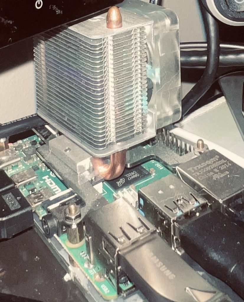 Raspberry Pi 4 fitted with a tower cooler and fan, with a Samsung USB stick plugged into a USB port